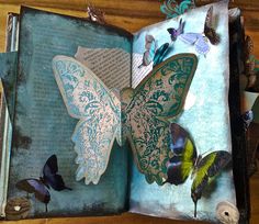 an open book with butterflies on it