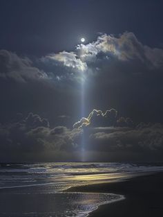 the sun shines brightly through clouds over the ocean