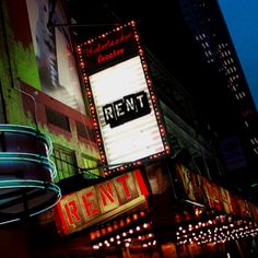 the neon signs are lit up on the building