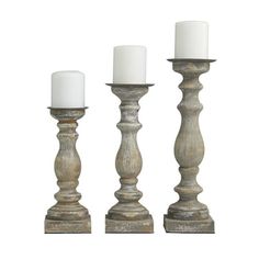 three wooden candlesticks sitting next to each other