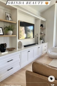 a living room with white cabinets and shelves