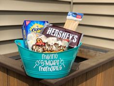 a bucket filled with snacks sitting on top of a wooden table