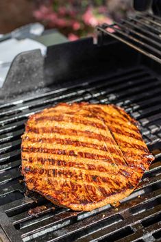 a steak is being grilled on the grill with it's top half removed