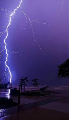 a lightning storm is seen over the ocean