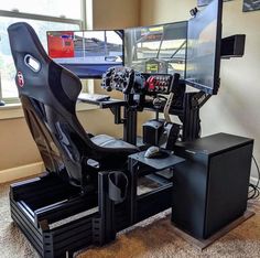 a computer desk with two monitors and a gaming chair in front of the monitor screen