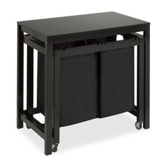 a black table with two trash cans on it's legs and one drawer open