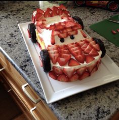 a cake made to look like a car with strawberries on it