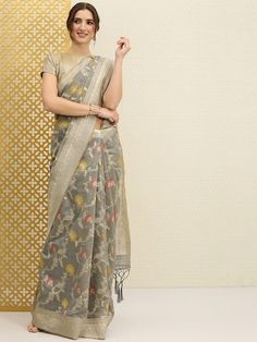 Grey and gold-toned sareeFloral woven design saree with zari and tasselled borderHas zari detailThe model is wearing the stitched blouse that comes with the saree Transitional Slub Silk Pre-draped Saree, Diwali Pre-draped Saree With Zari Weaving, Diwali Cotton Silk Pre-draped Saree, Cotton Silk Pre-draped Saree For Diwali, Slub Silk Choli For Festivals, Embroidered Paithani Silk Saree, Festive Tissue Silk Choli With Zari Weaving, Diwali Pre-draped Tussar Silk Saree, Diwali Banarasi Silk Blouse Piece