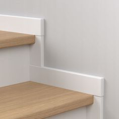 a close up view of some shelves with wood and white paint