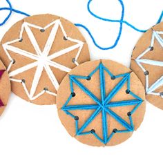 three wooden ornaments with string attached to them