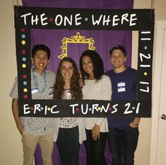 four people standing in front of a sign that says the one where eric turns 21