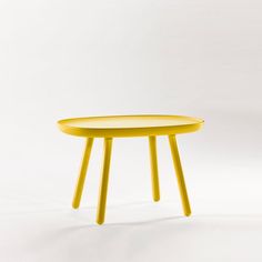 a yellow table sitting on top of a white floor