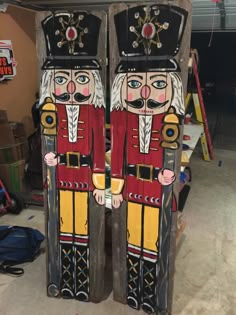 two large wooden nutcrackers are standing next to each other in the garage