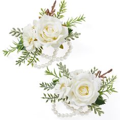 two white flowers and pearls are placed on the side of each flower headpieces