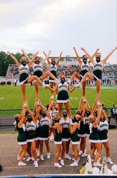 a group of cheerleaders standing on top of each other