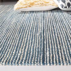 a blue rug with white and yellow accents