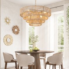 a dining room table with four chairs and a chandelier hanging from the ceiling