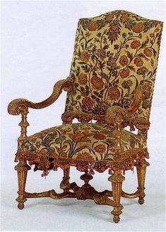 an ornately decorated arm chair on display