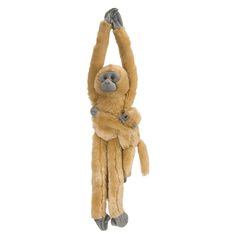 a stuffed monkey hanging from the ceiling with its hands up to it's head