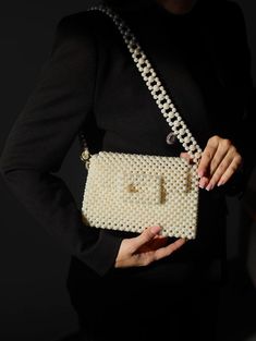 Handcrafted Beaded Pearl Bag - Elegant and Timeless Introducing our exquisite beaded pearl bag, a true embodiment of sophistication and style. Each bag is meticulously handcrafted with attention to detail, making it a unique accessory that will elevate any outfit. The timeless design of this bag makes it a versatile addition to your wardrobe. Whether you're attending a wedding, a cocktail party, or a casual brunch, this bag effortlessly complements any occasion. Compact yet spacious enough to ho Pearl White Bag With Pearl Handle, Pearl White Bag With Pearl Handle Rectangular, Pearl White Rectangular Bag With Pearl Handle, Cream Evening Bag With Pearl Handle, Cream Rectangular Shoulder Bag With Pearl Handle, Rectangular Shoulder Bag With Pearl Handle, Elegant White Bags With Pearl Chain, Elegant Handmade Rectangular Shoulder Bag, Elegant Square Handmade Shoulder Bag