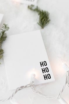 a white sheet with the word ho ho on it surrounded by christmas lights