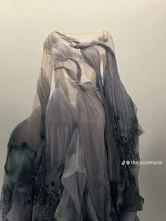 a dress made out of sheer fabric on display