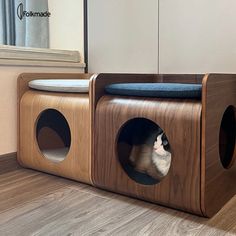 a cat sitting in a small wooden house