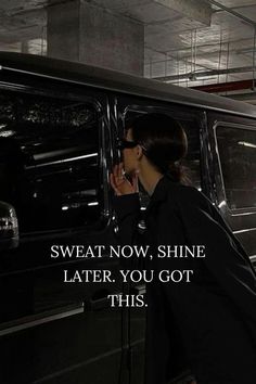 a woman talking on a cell phone next to a black van with the words sweat now, shine later you got this