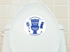 a close up of a toilet with a sticker on it