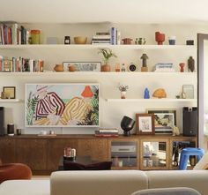 a living room filled with furniture and bookshelves