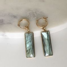 These gorgeous faceted natural labradorite earrings are made with rectangular shaped bezel set drops. The flash of labradorite's iridescent shimmer of blues and greens reminds us of Canada's lovely northern lights. -- 14kt gold-fill hoop diameter: 15mm Blues And Greens, Dangle Hoop Earrings, Gold Filled Hoops, Labradorite Earrings, Sterling Silver Hoops, Silver Hoops, The Flash, 14kt Gold, Pure Silver