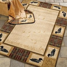 a rug with birds on it in front of a brick floor