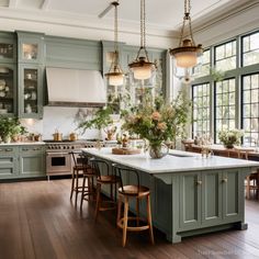 a kitchen filled with lots of green cabinets and counter top next to a stove top oven