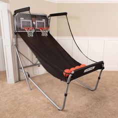 an indoor basketball game set up in the corner of a room with carpeted floor