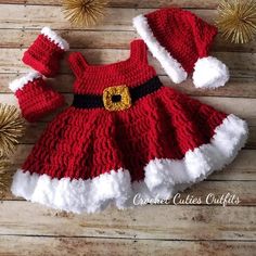 a red and white knitted christmas dress with santa claus's hat on it