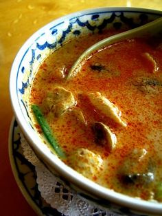 a bowl filled with soup on top of a wooden table