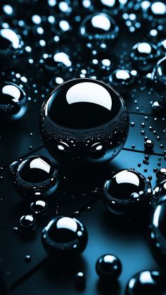 some black balls and water droplets on a table