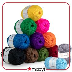 several balls of yarn are stacked up in different colors and sizes on a white background