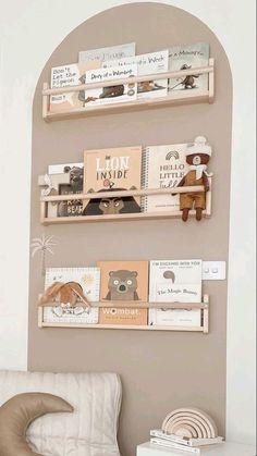 two wooden shelves with books and stuffed animals on them in the corner of a room