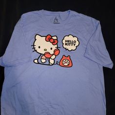 Brand New. Sanrio Hello Kitty,Size Large T Shirt. Super Cute, Perfect As A Gift Also. Blue Cat Print Summer Tops, Blue Cat Print Tops For Summer, Blue Cartoon Print Shirt For Spring, Cute Light Blue T-shirt With Cartoon Print, Casual Cat Design Short Sleeve Shirt, Casual Short Sleeve Shirt With Cat Design, Casual Blue Cat Print Top, Blue Casual Top With Cat Print, Casual Blue Tops With Cat Print