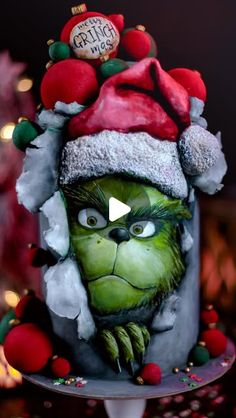 the grin face cake is decorated with red and green decorations