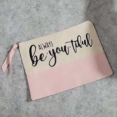 a pink and white pouch with the words always be you tiful written on it