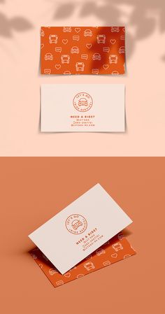 two business cards with different designs on them, one in orange and the other in white