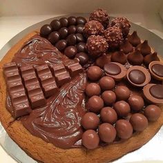 a cake with chocolates and candy bars on it