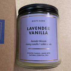 a jar of lavender blossom candle next to a cardboard box with the label on it