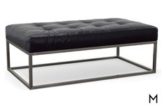 a black leather bench sitting on top of a metal frame