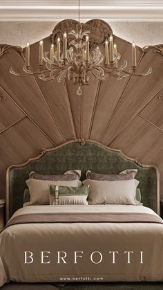 a bed with a chandelier above it and pillows on the bottom, in front of a wall