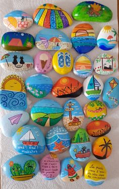 a bunch of rocks that have been painted on them and are sitting on a piece of paper