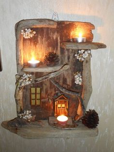 an image of a candle holder made out of wood and pine cones on the shelf