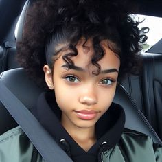 a young woman sitting in the back seat of a car